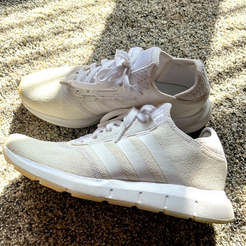 Women’s white Adidas shoes.